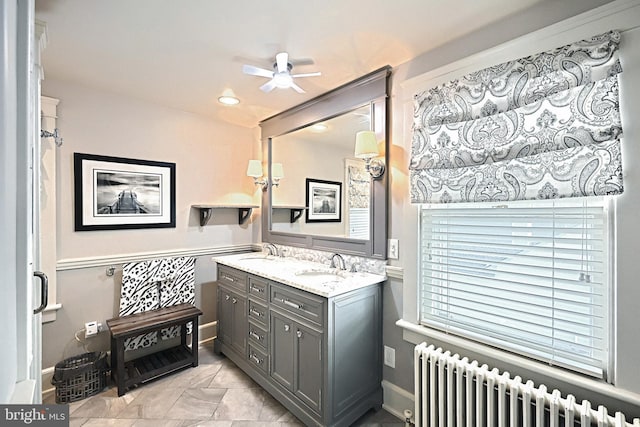 bathroom featuring vanity, radiator heating unit, and ceiling fan