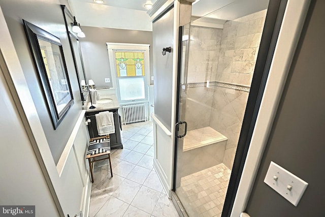 bathroom with vanity, radiator, and an enclosed shower