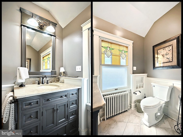 bathroom featuring lofted ceiling, radiator heating unit, toilet, and vanity