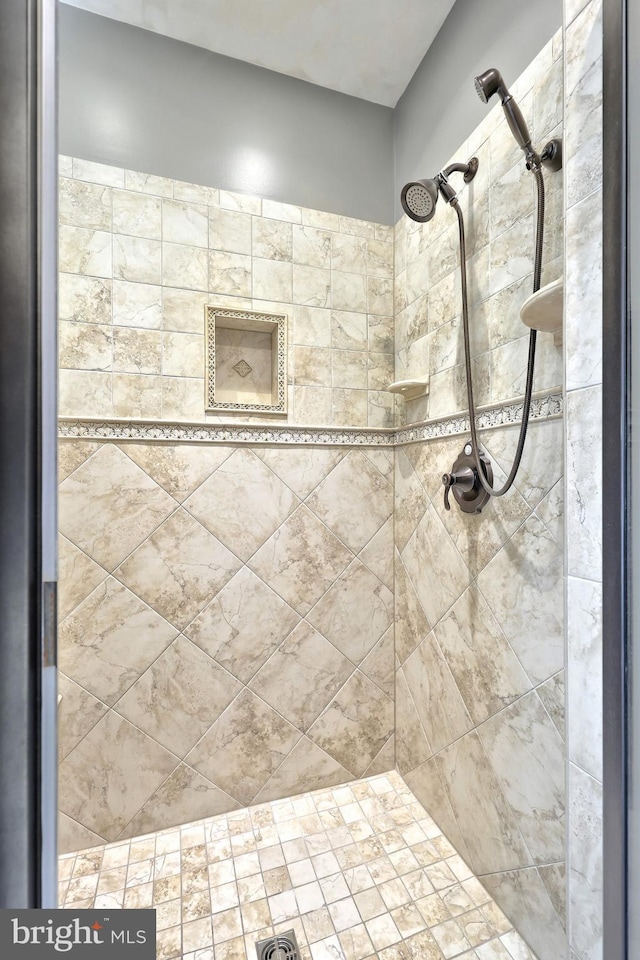 bathroom with a tile shower