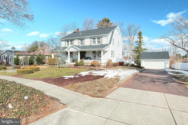 view of front of home with a garage, an outdoor structure, and a porch