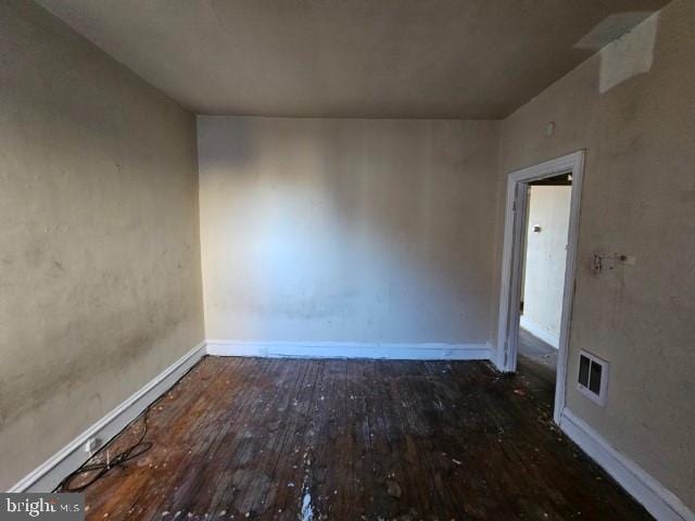 unfurnished room featuring dark hardwood / wood-style flooring