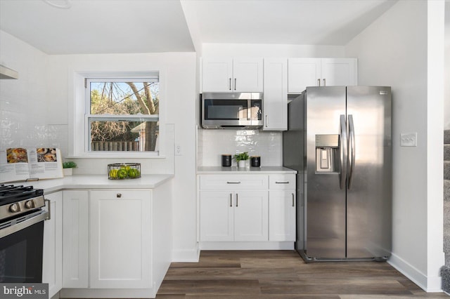 kitchen with backsplash, stainless steel appliances, dark hardwood / wood-style flooring, and white cabinets