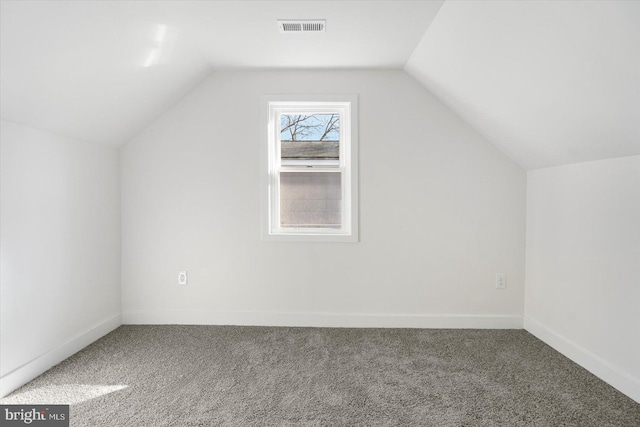 bonus room with lofted ceiling and carpet floors