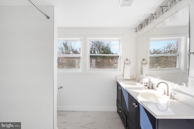 bathroom with vanity and a healthy amount of sunlight