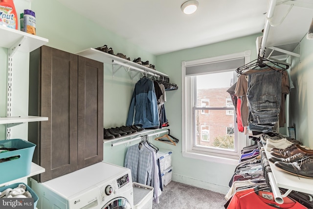 walk in closet featuring light colored carpet and washer / clothes dryer