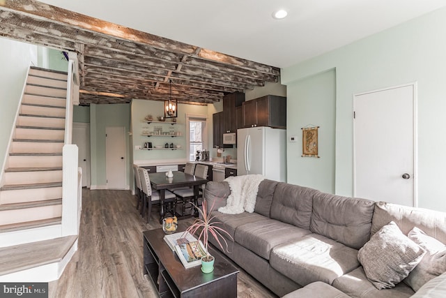 living room with a notable chandelier and light wood-type flooring