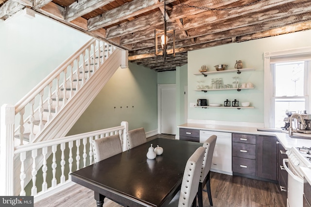 dining area featuring dark wood-type flooring and sink