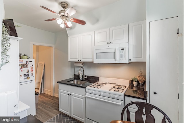 kitchen featuring dark hardwood / wood-style floors, sink, white cabinets, ceiling fan, and white appliances