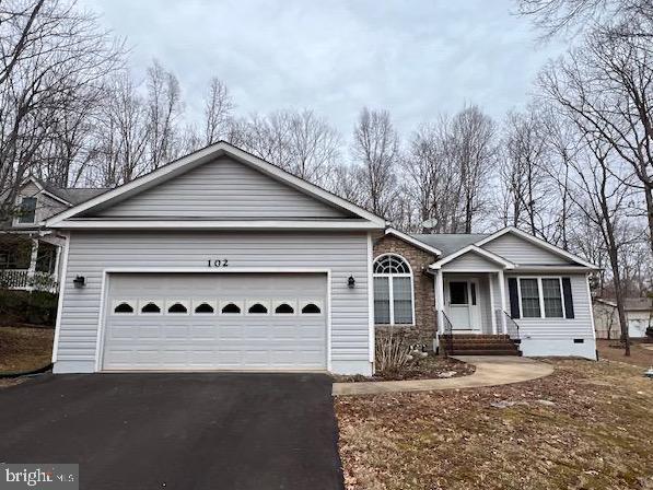 ranch-style home featuring a garage