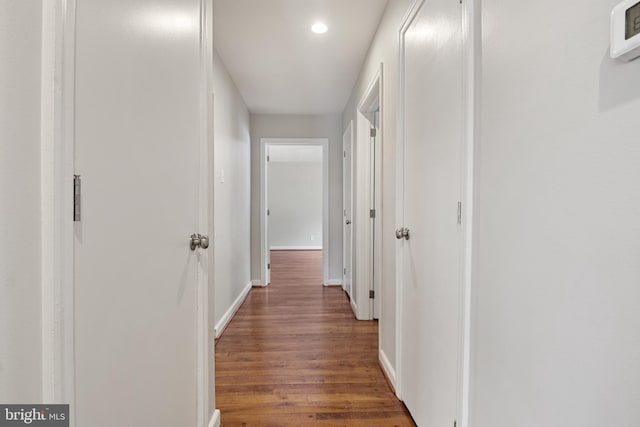 hall with dark wood-type flooring