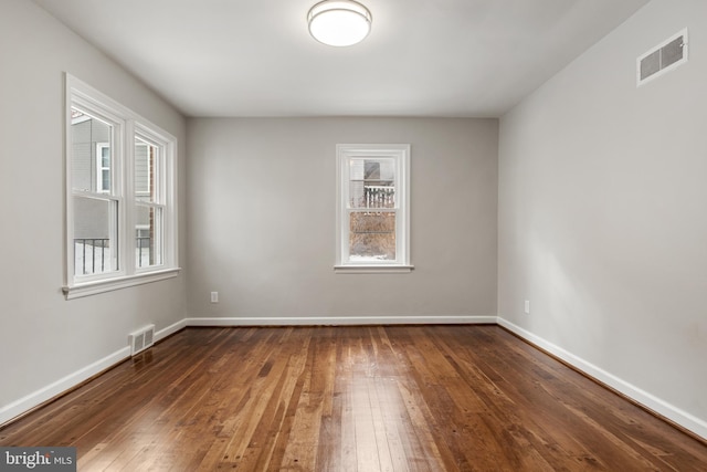 spare room with dark hardwood / wood-style flooring