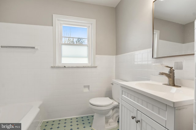 bathroom with vanity, tile walls, a washtub, and toilet