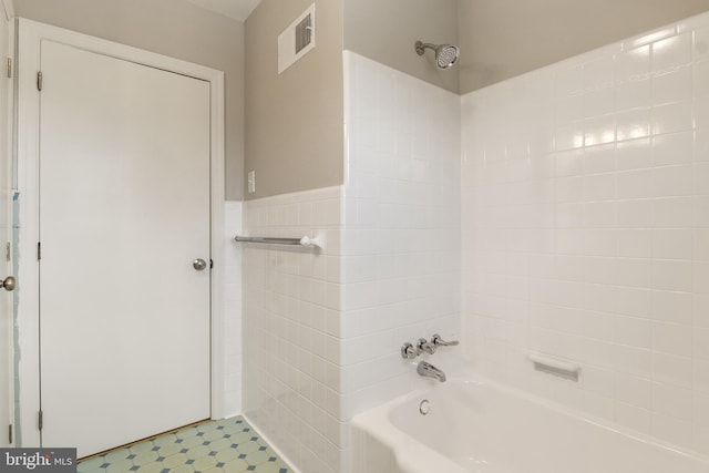 bathroom featuring tub / shower combination and tile walls