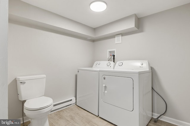 laundry room featuring separate washer and dryer and a baseboard heating unit