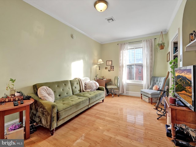 living room with ornamental molding and light wood-type flooring