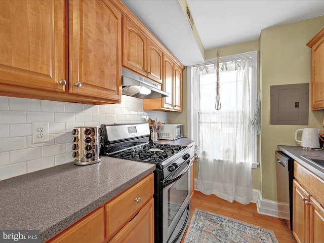 kitchen with stainless steel gas stove, tasteful backsplash, light wood-type flooring, electric panel, and dishwasher