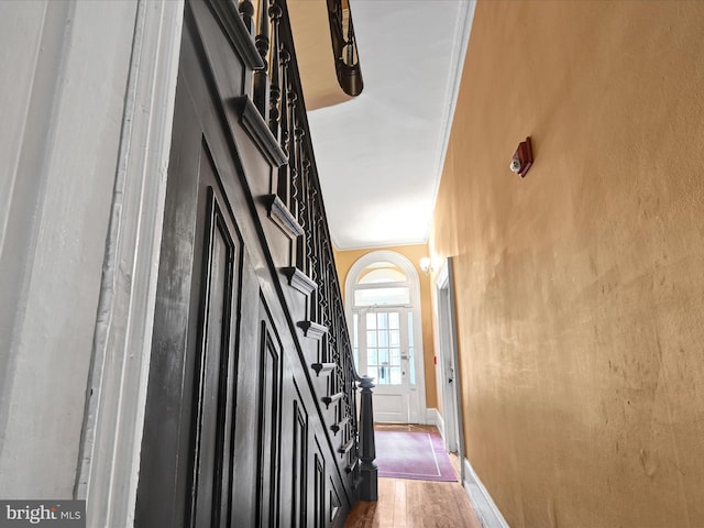 hallway featuring dark hardwood / wood-style flooring and ornamental molding