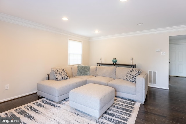 living area with visible vents, crown molding, and wood finished floors