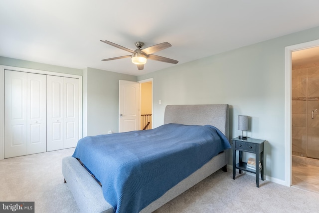 bedroom featuring a closet, baseboards, ensuite bathroom, and carpet