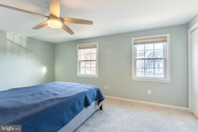 bedroom with ceiling fan, baseboards, and carpet floors