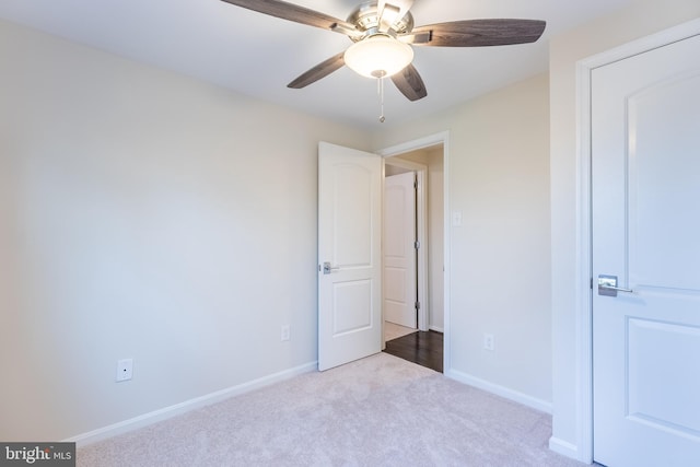 unfurnished bedroom with baseboards, carpet floors, and ceiling fan