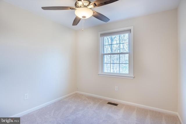 spare room featuring visible vents, ceiling fan, baseboards, and carpet floors