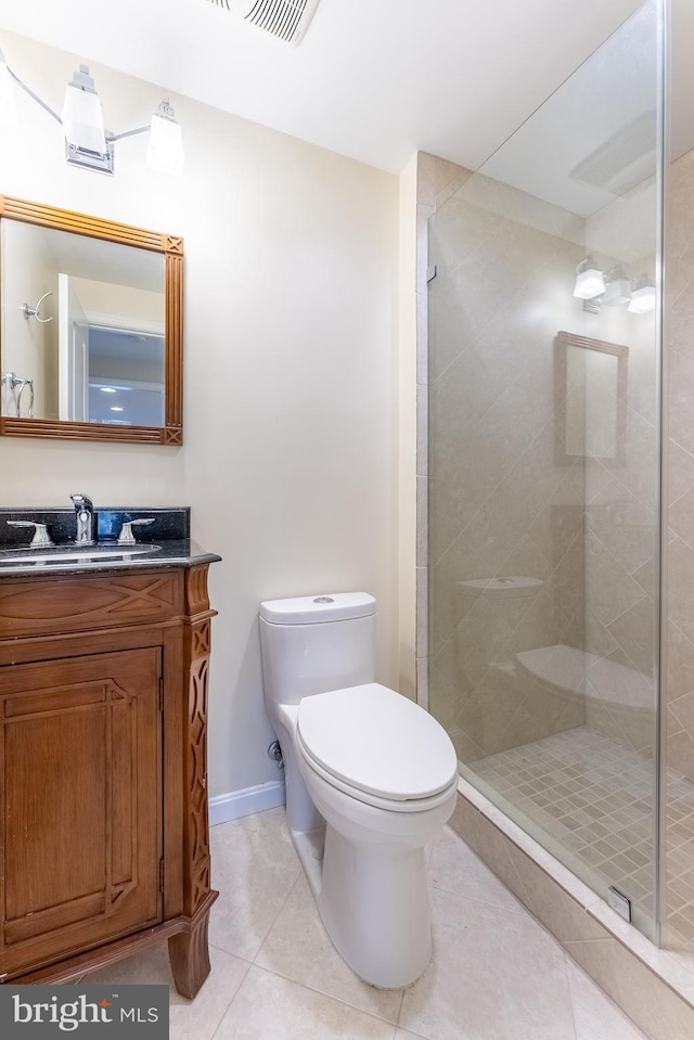 bathroom with tile patterned floors, a shower stall, toilet, and vanity