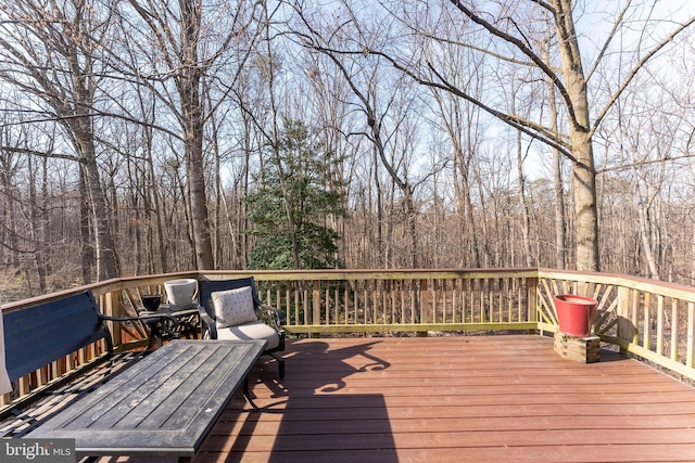 wooden deck with a forest view