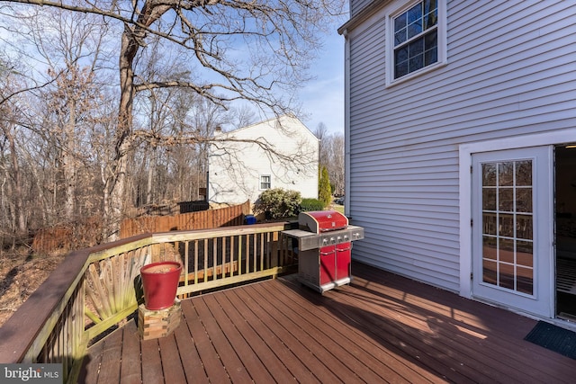 deck featuring area for grilling and fence