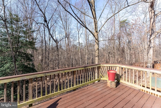 wooden terrace with a wooded view