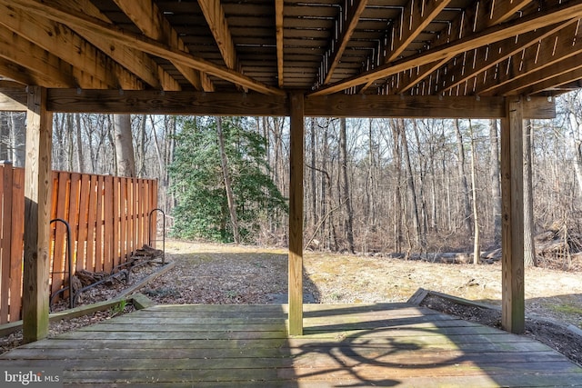 wooden terrace featuring a forest view