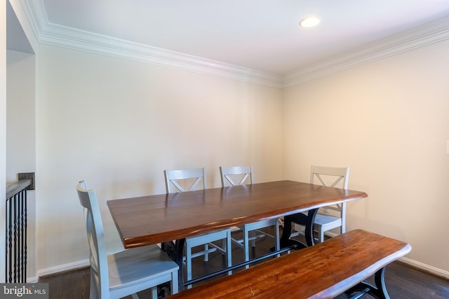 dining space with baseboards, dark wood finished floors, and ornamental molding