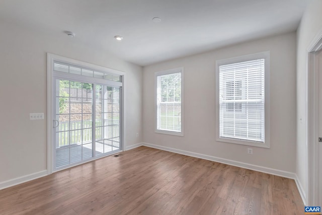 spare room with hardwood / wood-style flooring