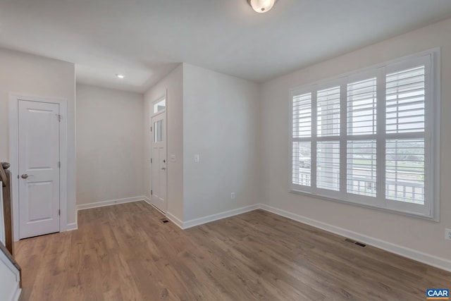 unfurnished room featuring hardwood / wood-style flooring