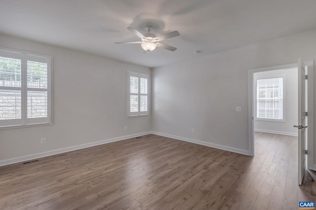 unfurnished room with hardwood / wood-style flooring and ceiling fan