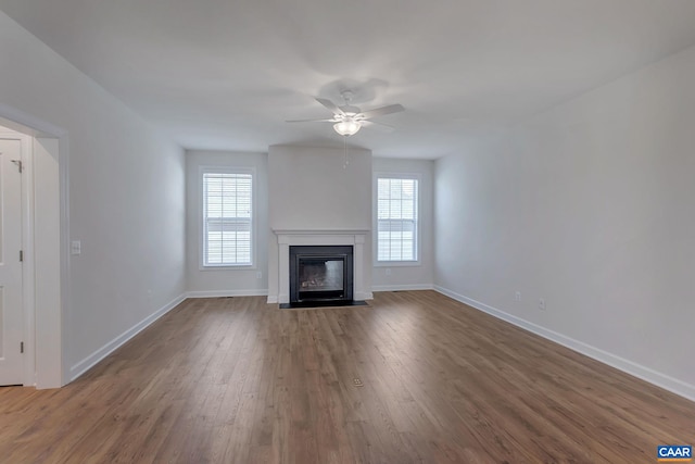 unfurnished living room featuring hardwood / wood-style flooring, plenty of natural light, and ceiling fan