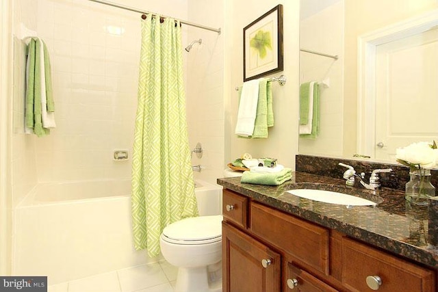 full bathroom with tile patterned flooring, vanity, shower / bath combo with shower curtain, and toilet