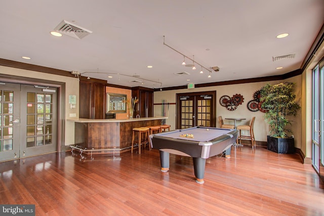 recreation room with french doors, billiards, wood-type flooring, bar area, and track lighting