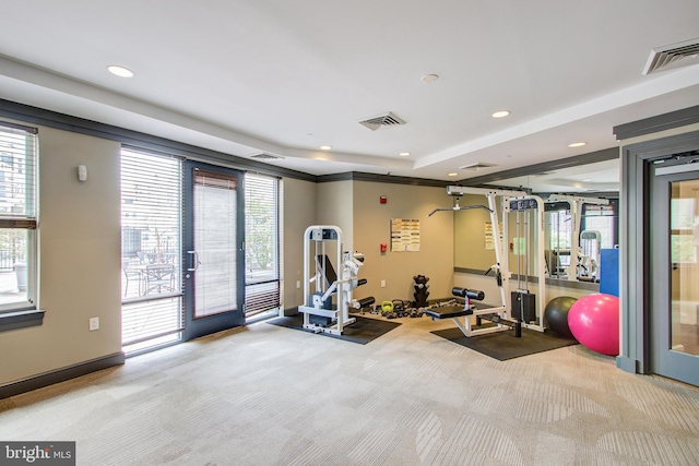 workout room with plenty of natural light, light carpet, and french doors