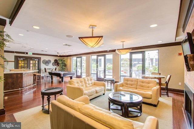 living room with crown molding, wood-type flooring, a wealth of natural light, and pool table