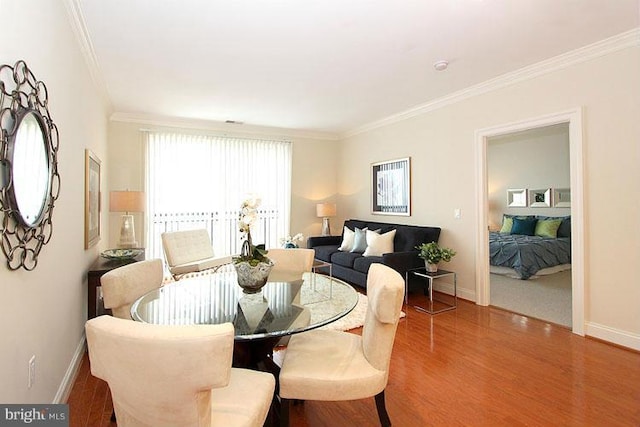 dining area featuring crown molding and wood-type flooring