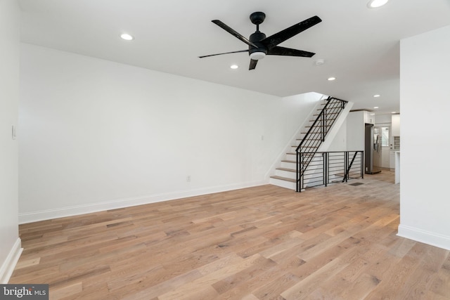 unfurnished living room featuring ceiling fan and light hardwood / wood-style floors