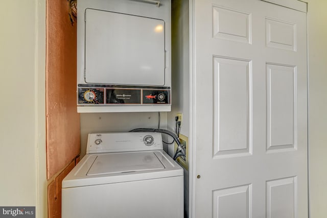 laundry area featuring stacked washer / drying machine