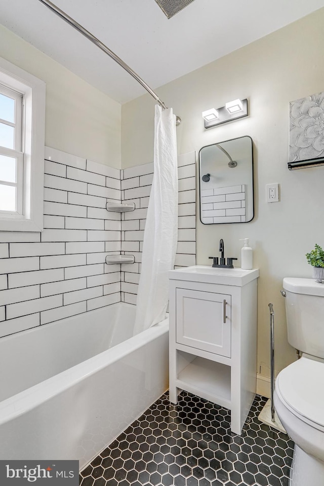 full bathroom with vanity, shower / tub combo, tile patterned floors, and toilet