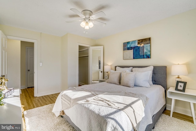 bedroom with a closet, ceiling fan, and light wood-type flooring