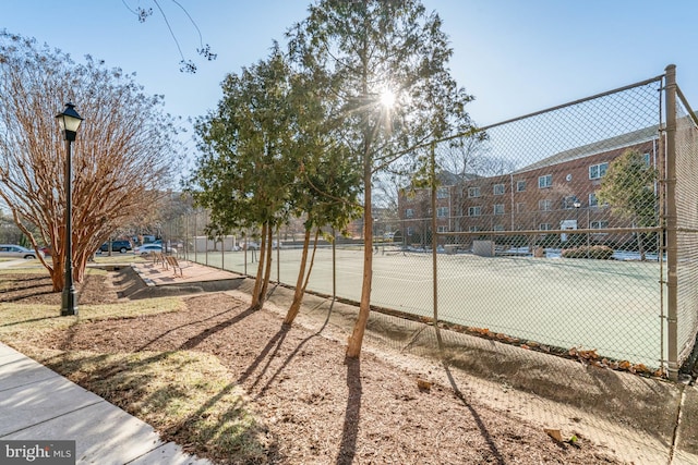 view of community featuring tennis court