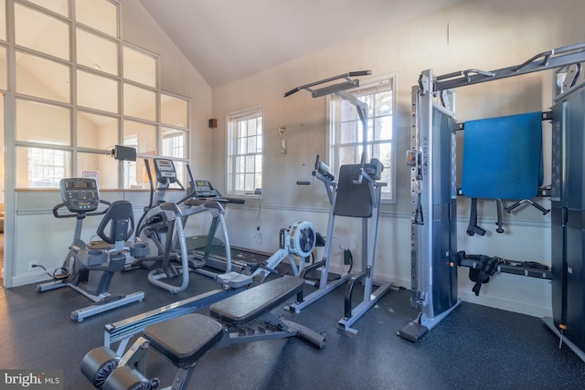 gym featuring lofted ceiling and plenty of natural light