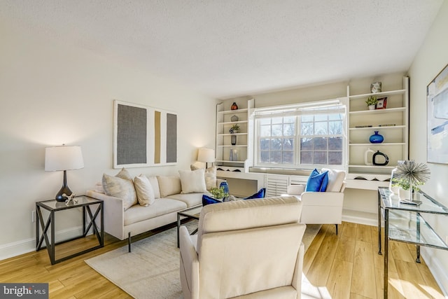 living room featuring hardwood / wood-style floors and a textured ceiling