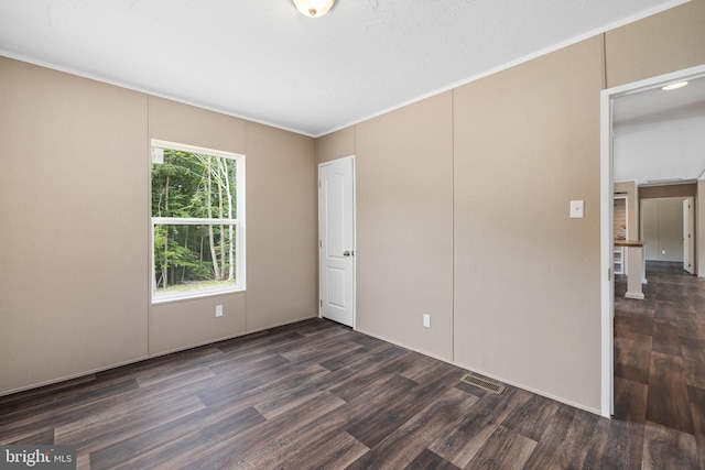 spare room with dark hardwood / wood-style flooring